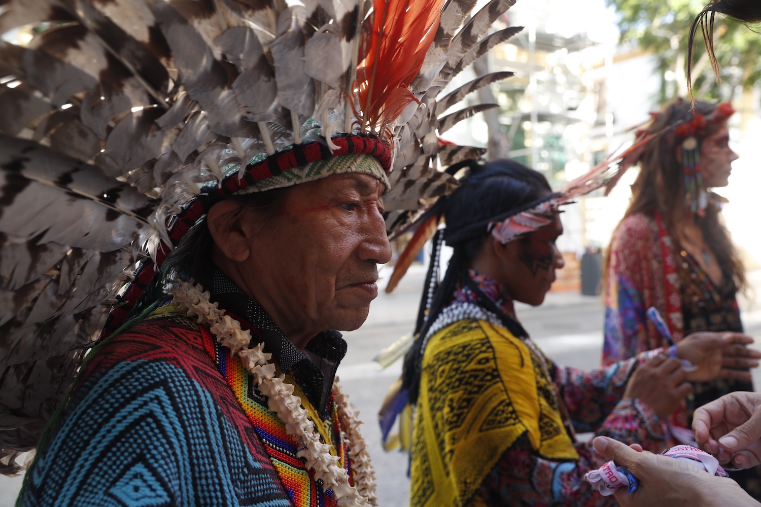 Indigenous performers in ceremonial feathered headdresses at ROLA Ibiza